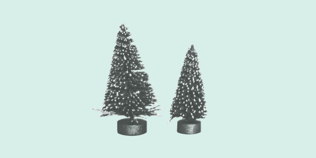 Tiny decorative pine trees on a light green background. Holiday Stress.