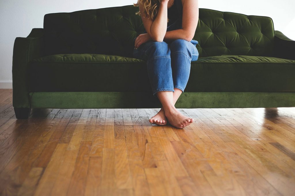 woman-sitting-on-green-couch