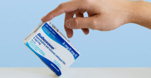 A hand tips a box of Suboxone (buprenorphine/naloxone) up on one corner