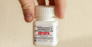 A white plactic bottle of generic buprenorphine/naloxone tablets.