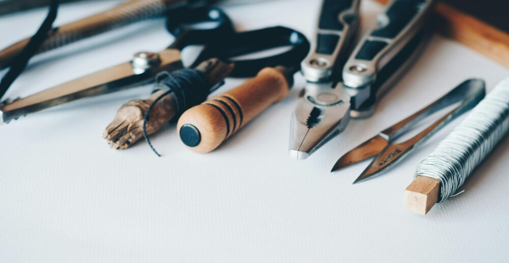 A line of hand tools lying on a white background