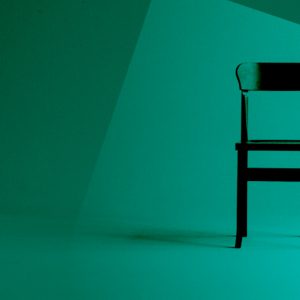 An empty chair standing alone, with a green color overlay. Why I left AA