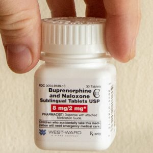 A white plactic bottle of generic buprenorphine/naloxone tablets.