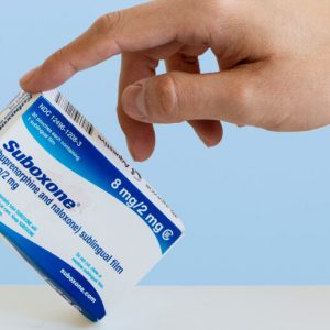 A hand tips a box of Suboxone (buprenorphine/naloxone) up on one corner